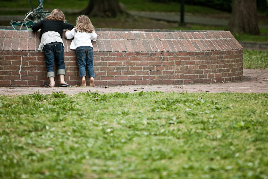 girls making a wish in a well