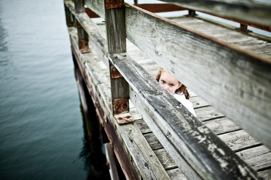 child peaking through rail